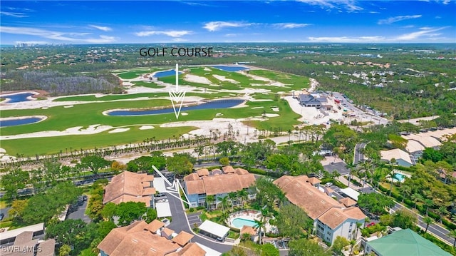 view of property location featuring a large body of water, a golf club, and nearby suburban area
