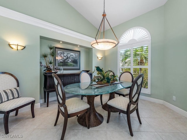 dining room with baseboards, light tile patterned floors, and high vaulted ceiling