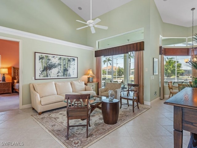 tiled living area with high vaulted ceiling, ceiling fan, baseboards, and a chandelier
