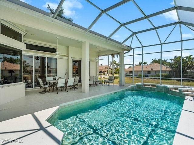 view of pool featuring a patio area, a lanai, ceiling fan, and a pool with connected hot tub