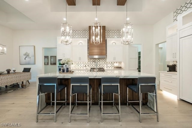 6145 Sea Grass Ln, Naples, FL 34116 - kitchen featuring a chandelier, backsplash, white cabinetry, and light wood finished floors