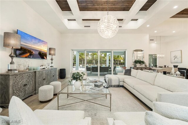6145 Sea Grass Ln, Naples, FL 34116 - living room with a chandelier, wood finished floors, a high ceiling, coffered ceiling, and beam ceiling