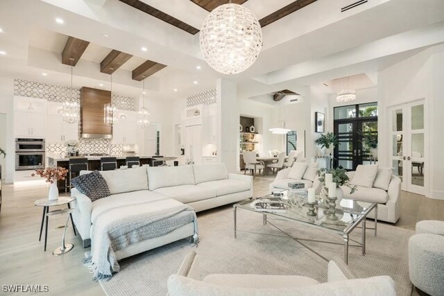 6145 Sea Grass Ln, Naples, FL 34116 - living room featuring a chandelier, light wood-style floors, beam ceiling, recessed lighting, and a towering ceiling