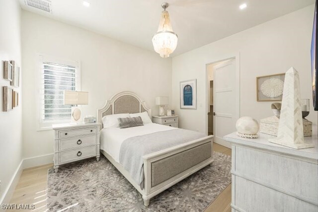 6145 Sea Grass Ln, Naples, FL 34116 - bedroom featuring light wood-type flooring, baseboards, recessed lighting, and a chandelier
