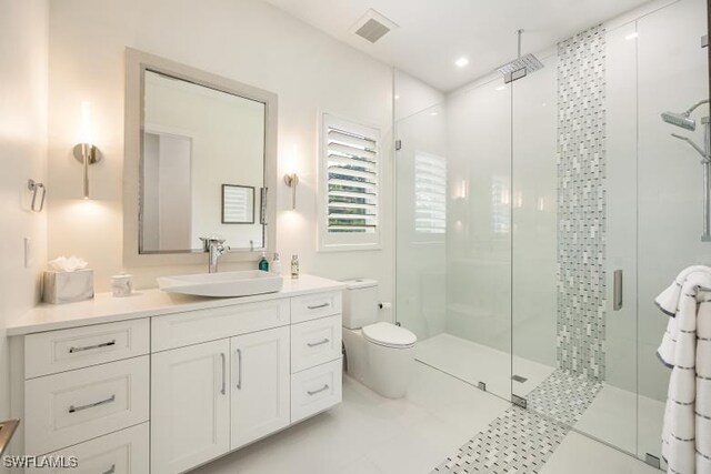 6145 Sea Grass Ln, Naples, FL 34116 - bathroom featuring a shower stall, toilet, vanity, and recessed lighting
