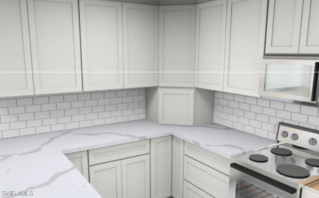 16881 Davis Rd Unit 412, Fort Myers, FL 33908 - kitchen with electric stove, tasteful backsplash, light stone counters, and stainless steel microwave
