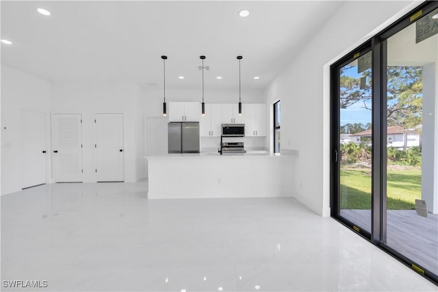 2815 32nd St W, Lehigh Acres, FL 33971 - kitchen with stainless steel appliances, recessed lighting, white cabinets, a peninsula, and decorative light fixtures
