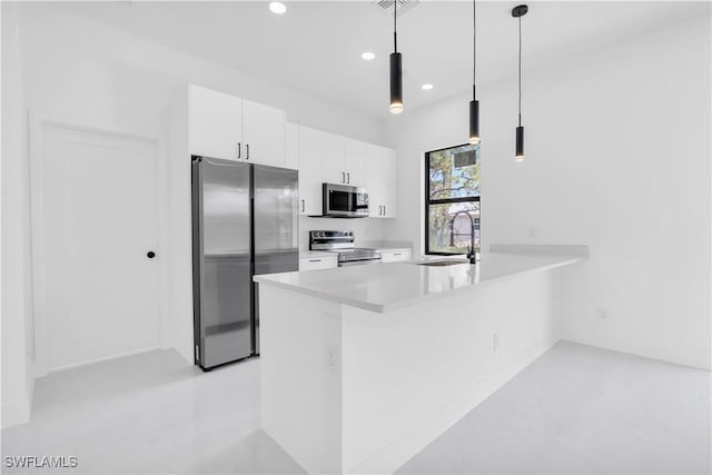 2815 32nd St W, Lehigh Acres, FL 33971 - kitchen with stainless steel appliances, a sink, a peninsula, white cabinetry, and recessed lighting