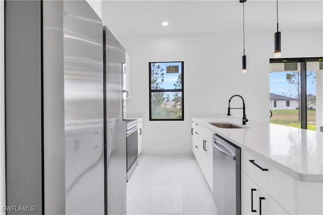 2815 32nd St W, Lehigh Acres, FL 33971 - kitchen with a sink, appliances with stainless steel finishes, modern cabinets, white cabinets, and baseboards