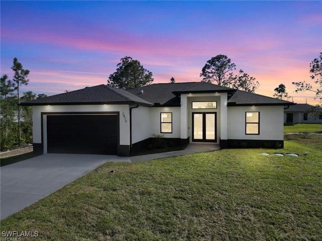 2815 32nd St W, Lehigh Acres, FL 33971 - prairie-style house with french doors, a garage, concrete driveway, and stucco siding