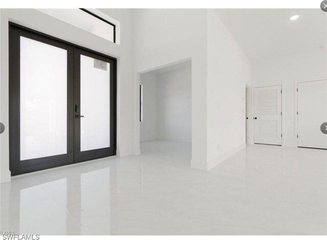 2815 32nd St W, Lehigh Acres, FL 33971 - entryway with tile patterned floors, french doors, and recessed lighting