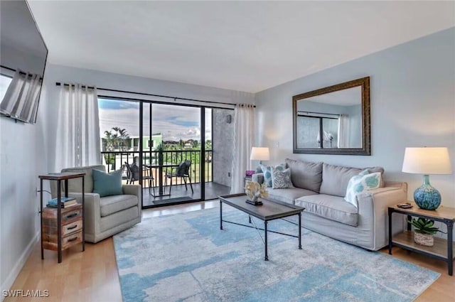 260 Southbay Dr Unit 103, Naples, FL 34108 - living area featuring baseboards and wood finished floors