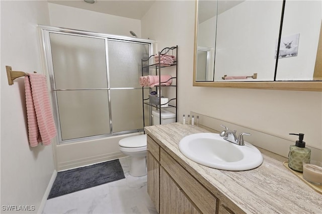 bathroom featuring toilet, vanity, shower / bath combination with glass door, marble finish floors, and baseboards