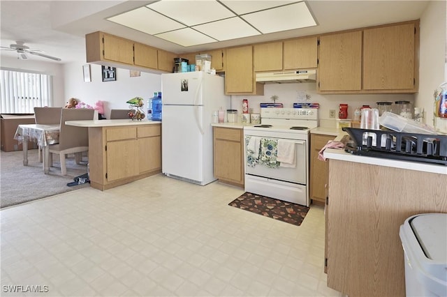 kitchen with white appliances, under cabinet range hood, light flooring, a peninsula, and light countertops