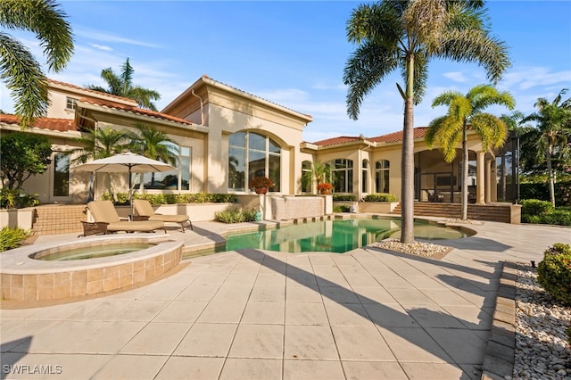 6387 Highcroft Dr, Naples, FL 34119 - back of house featuring an in-ground hot tub, a patio, stucco siding, an outdoor pool, and a tiled roof