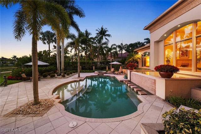 6387 Highcroft Dr, Naples, FL 34119 - pool at dusk with a patio, fence, and a pool with connected hot tub
