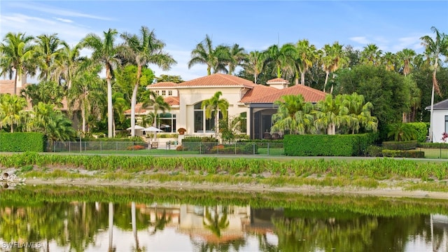 6387 Highcroft Dr, Naples, FL 34119 - rear view of property with a tile roof, fence, stucco siding, and a water view