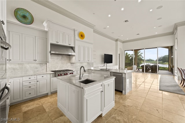 6387 Highcroft Dr, Naples, FL 34119 - kitchen with under cabinet range hood, a sink, appliances with stainless steel finishes, a center island with sink, and ornamental molding