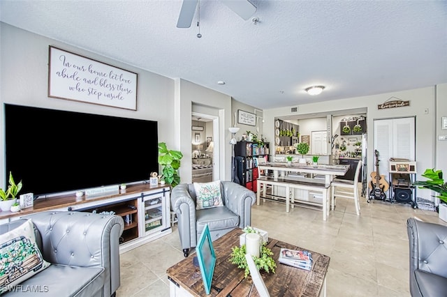 13160 Bella Casa Cir Unit 2115, Fort Myers, FL 33966 - living area with a ceiling fan, a textured ceiling, and light tile patterned floors