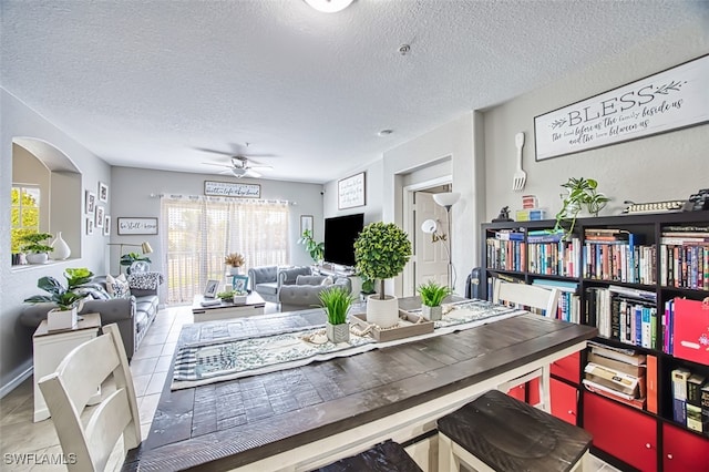 13160 Bella Casa Cir Unit 2115, Fort Myers, FL 33966 - tiled dining area with a textured ceiling and a ceiling fan