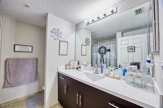 13160 Bella Casa Cir Unit 2115, Fort Myers, FL 33966 - full bath with toilet, vanity, a shower with shower curtain, tile patterned floors, and a textured ceiling