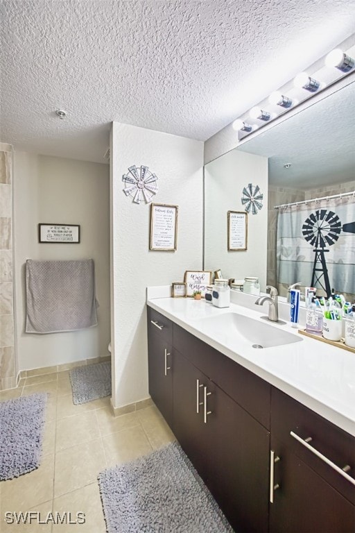 13160 Bella Casa Cir Unit 2115, Fort Myers, FL 33966 - bathroom featuring a textured ceiling, vanity, tile patterned flooring, a shower with curtain, and toilet