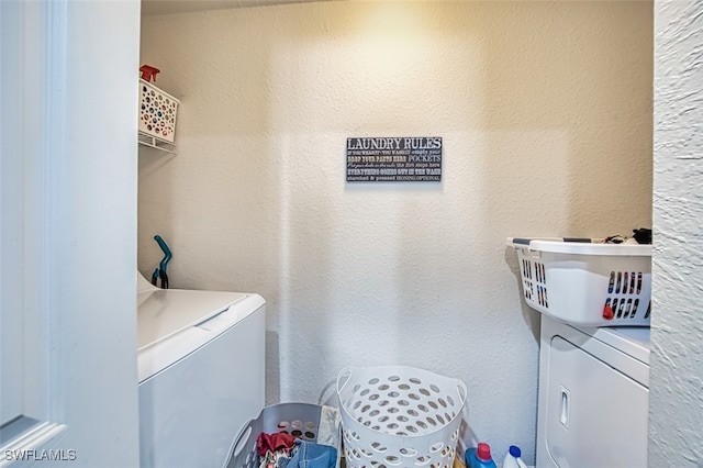 13160 Bella Casa Cir Unit 2115, Fort Myers, FL 33966 - laundry area featuring washer and clothes dryer and a textured wall