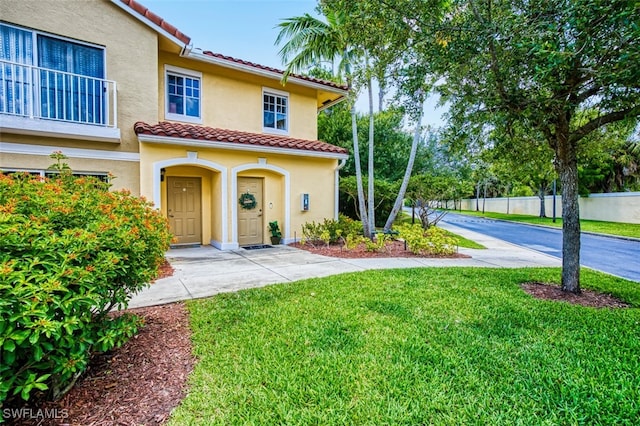 13160 Bella Casa Cir Unit 2115, Fort Myers, FL 33966 - view of front facade featuring a tiled roof and stucco siding
