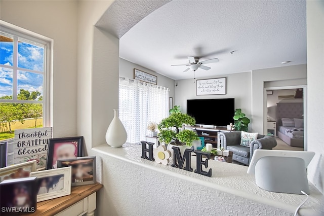 13160 Bella Casa Cir Unit 2115, Fort Myers, FL 33966 - living room with a ceiling fan and a textured ceiling