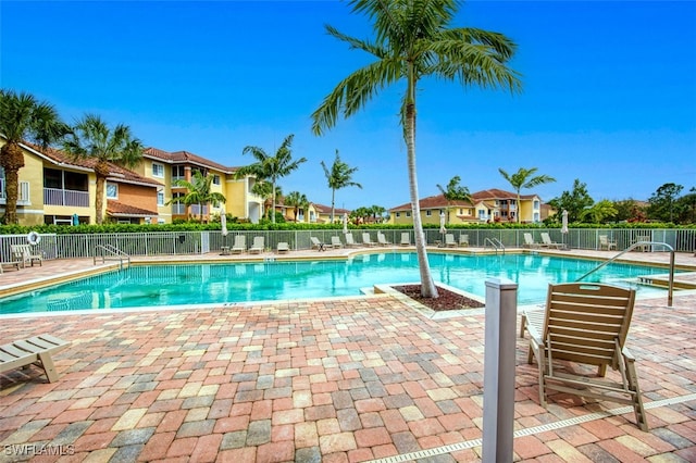 13160 Bella Casa Cir Unit 2115, Fort Myers, FL 33966 - community pool featuring fence, a patio area, and a residential view