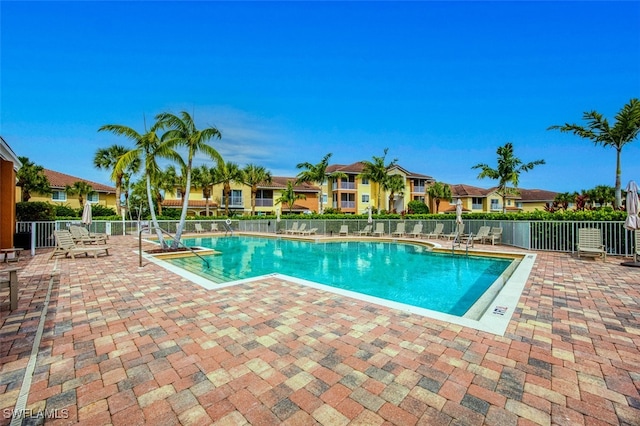 13160 Bella Casa Cir Unit 2115, Fort Myers, FL 33966 - community pool featuring fence, a patio area, and a residential view