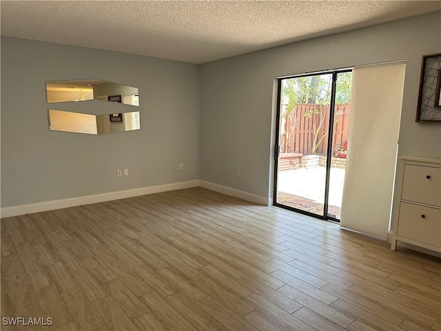 5226 Cedarbend Dr Unit 2, Fort Myers, FL 33919 - empty room with wood finished floors, a textured ceiling, and baseboards