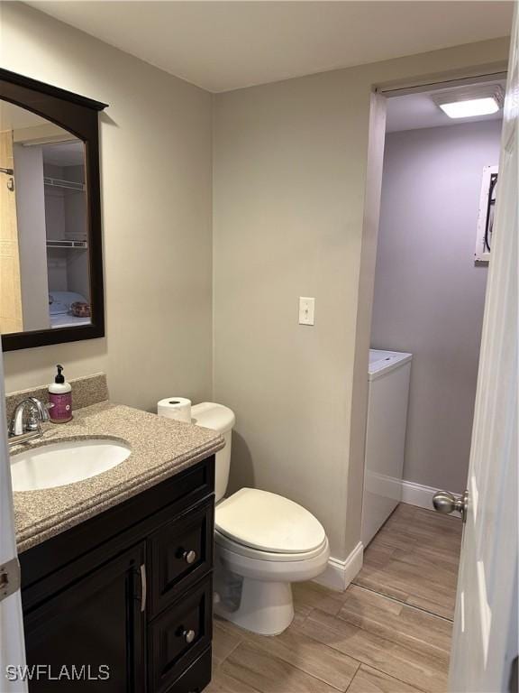 5226 Cedarbend Dr Unit 2, Fort Myers, FL 33919 - bathroom featuring toilet, vanity, wood finished floors, and baseboards