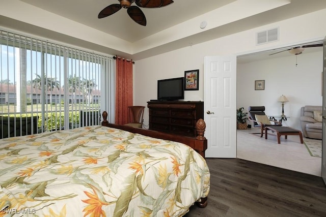 2386 Magnolia Ave Unit 7801, Naples, FL 34112 - bedroom with dark wood finished floors, a raised ceiling, and ceiling fan
