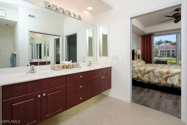 2386 Magnolia Ave Unit 7801, Naples, FL 34112 - ensuite bathroom featuring tile patterned floors, a ceiling fan, double vanity, and baseboards