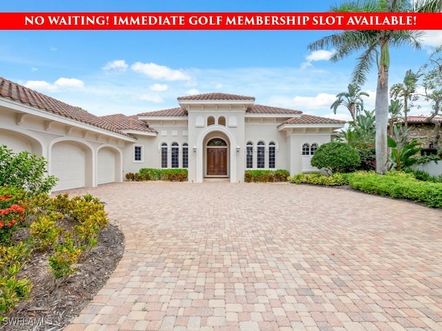 16465 Celebrita Ct, Naples, FL 34110 - view of front facade featuring decorative driveway, an attached garage, stucco siding, and a tiled roof