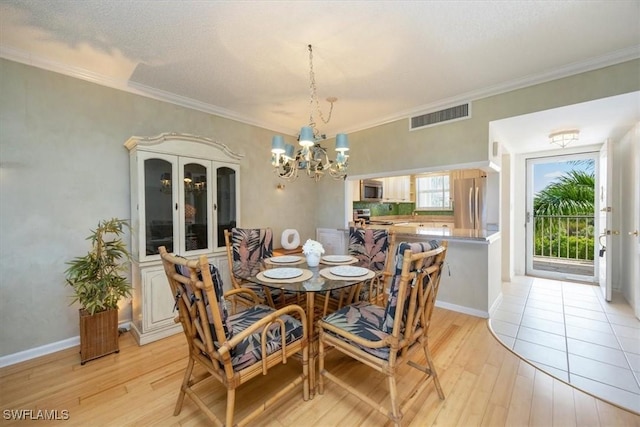 21 High Point Cir E Unit 502, Naples, FL 34103 - dining room featuring light wood finished floors, a chandelier, crown molding, and baseboards