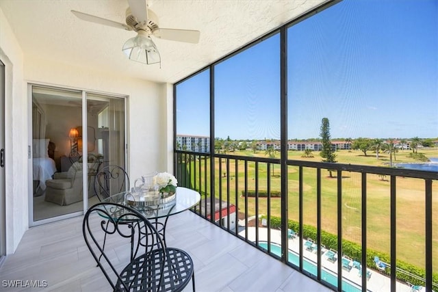 21 High Point Cir E Unit 502, Naples, FL 34103 - sunroom featuring a ceiling fan, expansive windows, and outdoor dining area