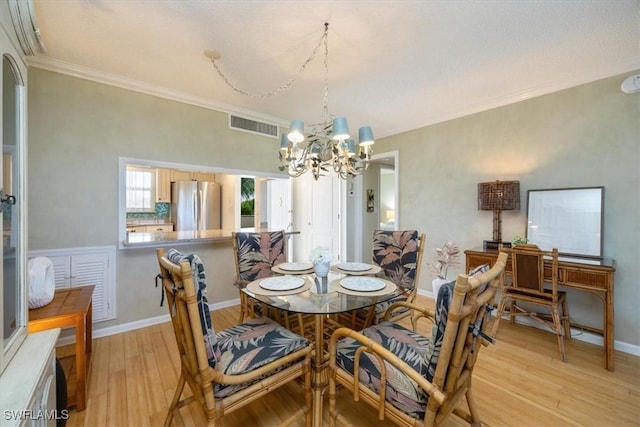 21 High Point Cir E Unit 502, Naples, FL 34103 - dining room with a chandelier, light wood-type flooring, crown molding, and baseboards