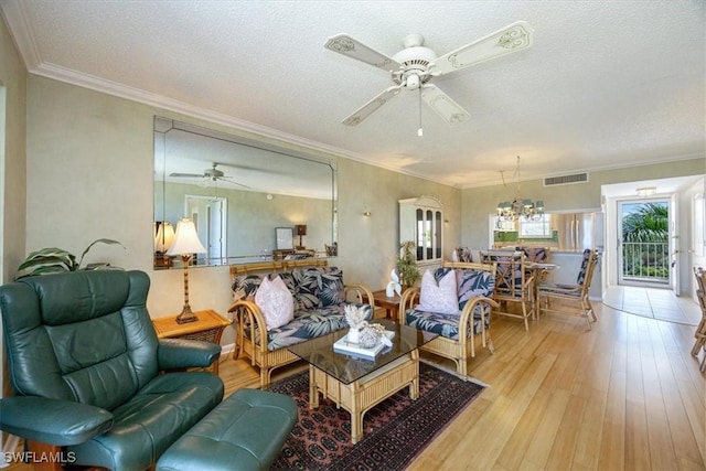 21 High Point Cir E Unit 502, Naples, FL 34103 - living room featuring a ceiling fan, hardwood / wood-style flooring, a chandelier, ornamental molding, and a textured ceiling