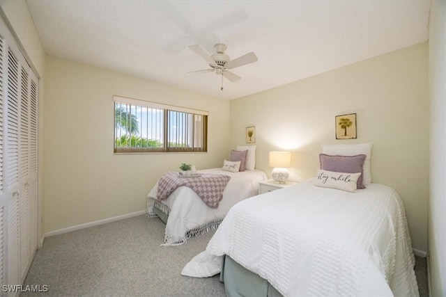 21 High Point Cir E Unit 502, Naples, FL 34103 - carpeted bedroom with a closet, a ceiling fan, and baseboards