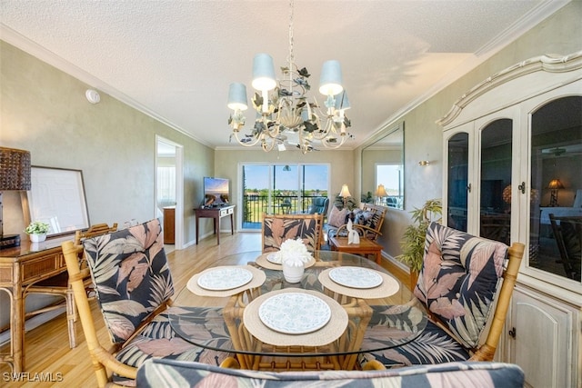 21 High Point Cir E Unit 502, Naples, FL 34103 - dining space with a chandelier, light wood-style flooring, ornamental molding, baseboards, and a textured ceiling