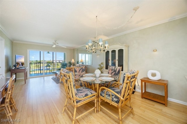 21 High Point Cir E Unit 502, Naples, FL 34103 - dining space featuring a chandelier, light wood-style floors, crown molding, and baseboards