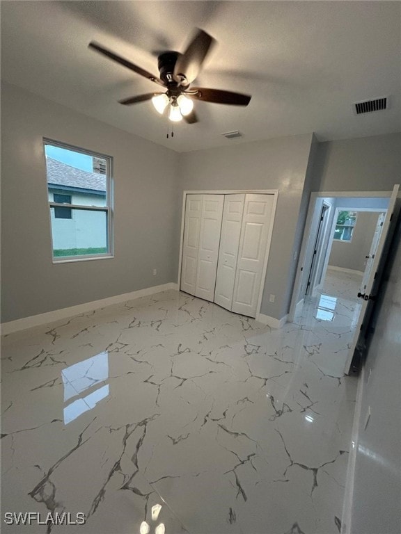 unfurnished bedroom featuring baseboards, a closet, and ceiling fan