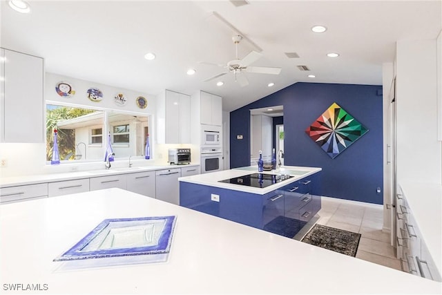 12439 Prather Ave, Port Charlotte, FL 33981 - kitchen with white appliances, modern cabinets, white cabinets, a ceiling fan, and lofted ceiling