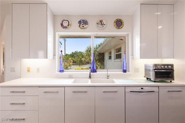12439 Prather Ave, Port Charlotte, FL 33981 - kitchen with dishwasher, a sink, light countertops, white cabinets, and modern cabinets
