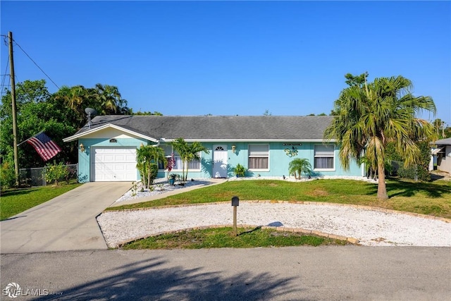 1303 Thompson St, North Fort Myers, FL 33903 - ranch-style home featuring concrete driveway, a front yard, an attached garage, and stucco siding