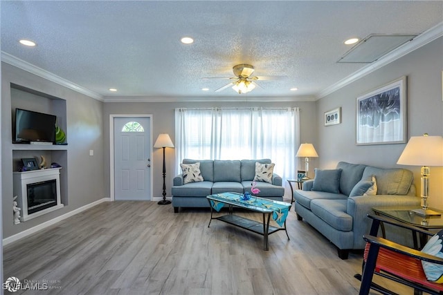 1303 Thompson St, North Fort Myers, FL 33903 - living room featuring light wood finished floors, ornamental molding, a ceiling fan, a textured ceiling, and recessed lighting