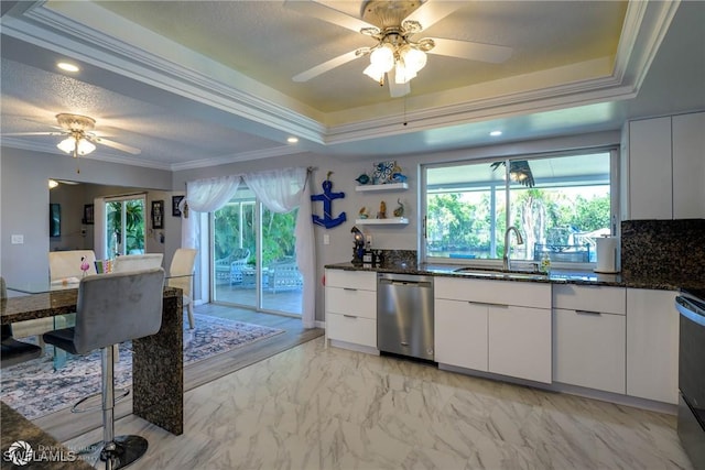 1303 Thompson St, North Fort Myers, FL 33903 - kitchen with dishwasher, a sink, a ceiling fan, a raised ceiling, and crown molding