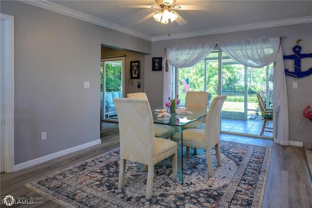 1303 Thompson St, North Fort Myers, FL 33903 - dining area featuring a ceiling fan, wood finished floors, crown molding, a textured ceiling, and baseboards